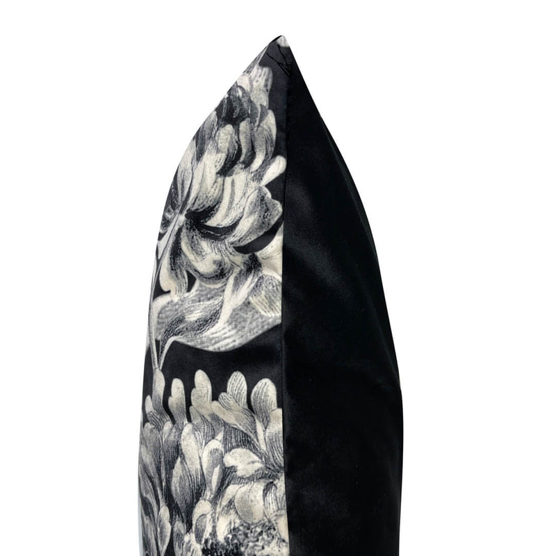 Side view of decorative black floral and monkeys velvet cushion