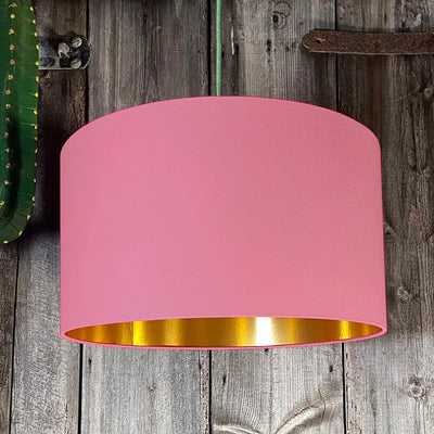 Handmade dirty pink lampshade emits warm glow with gold lining. Perfect for pendants, floor or table lamps.